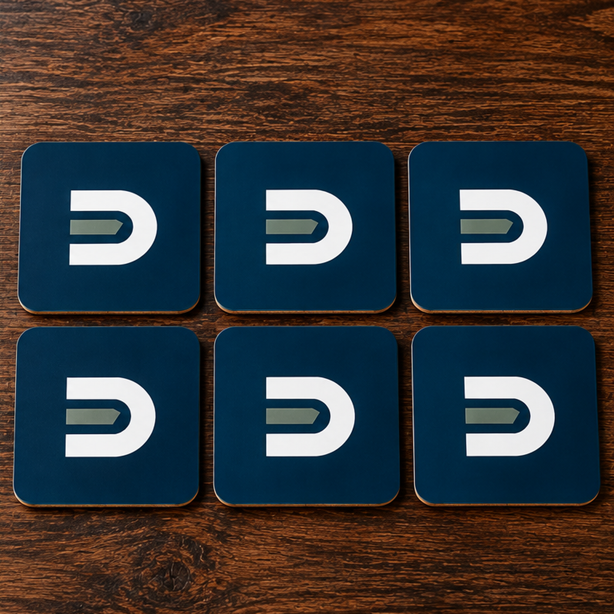 Six navy Dads in the Game D emblem coasters arranged in two rows on a wooden table